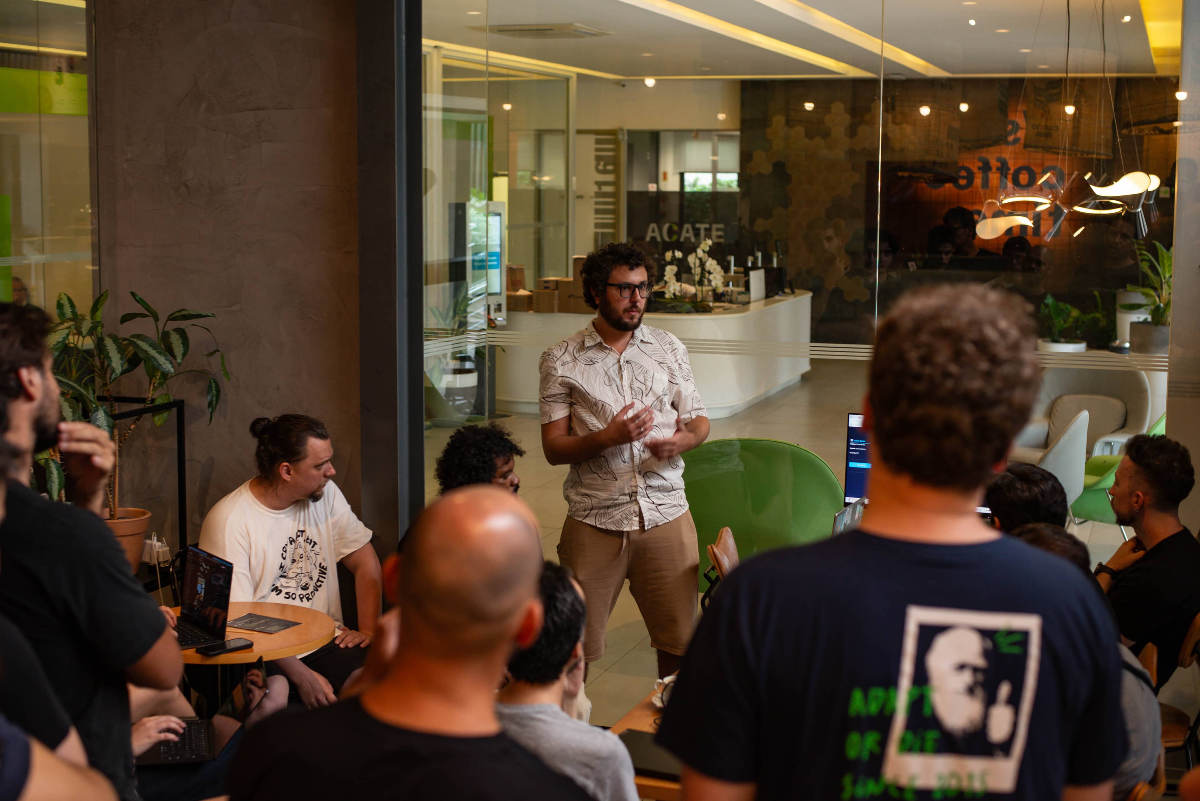A Cafe Cursor gathering with developers working together over coffee.